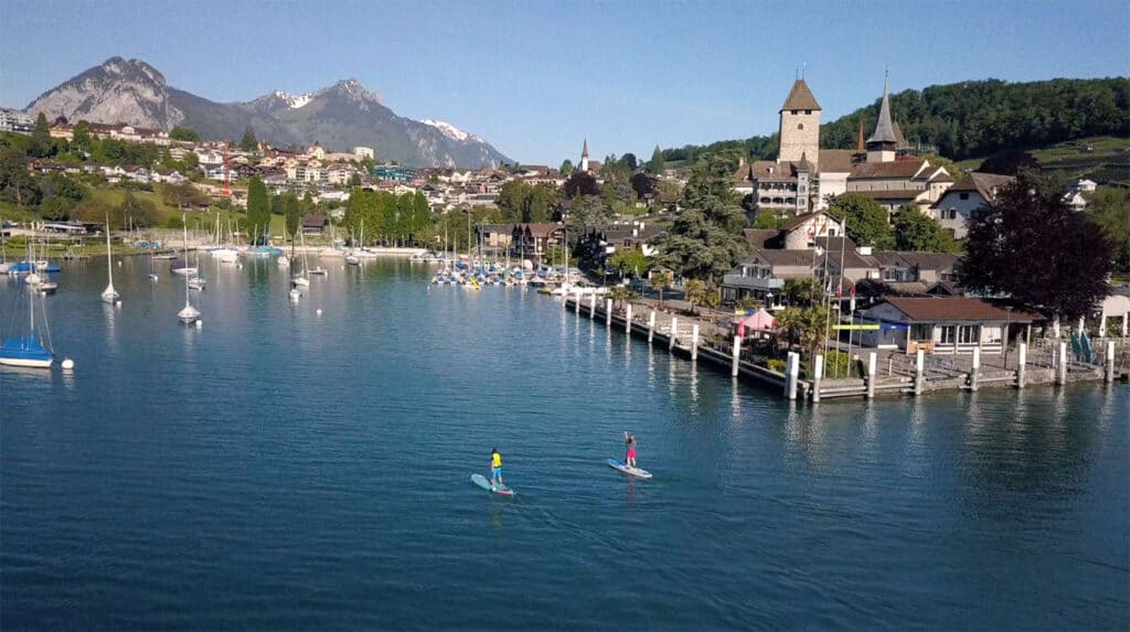 Paddleboarder in the bay of Spiez with the castle