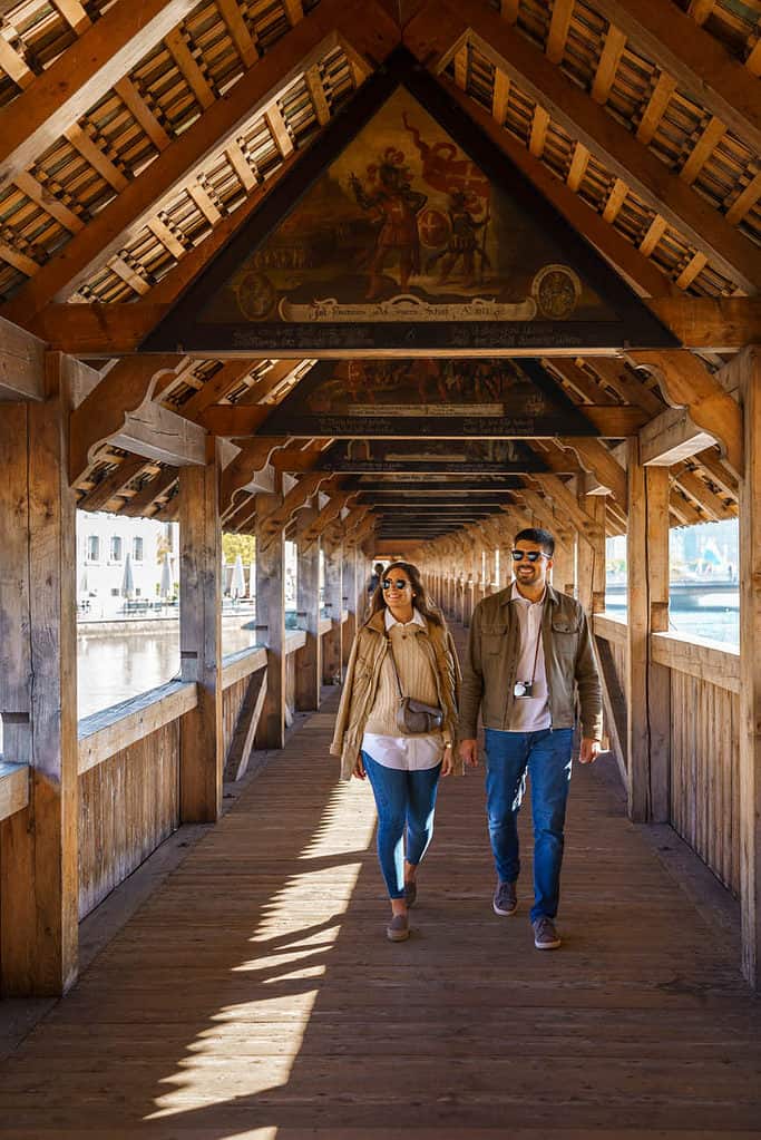 People walking on chapel bridge in Lucerne