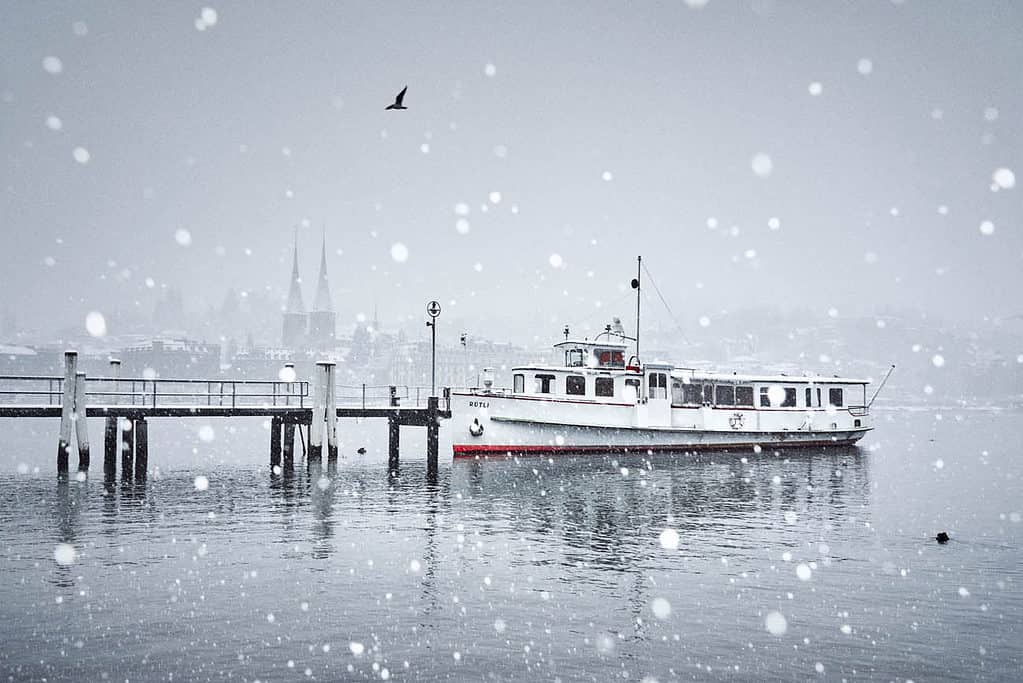 A lake lucerne boat in winter during snowfall