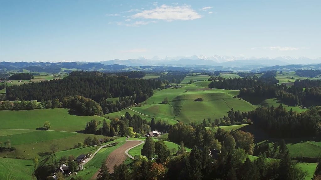 Emmental landscape seen from a drone with the alps in the background