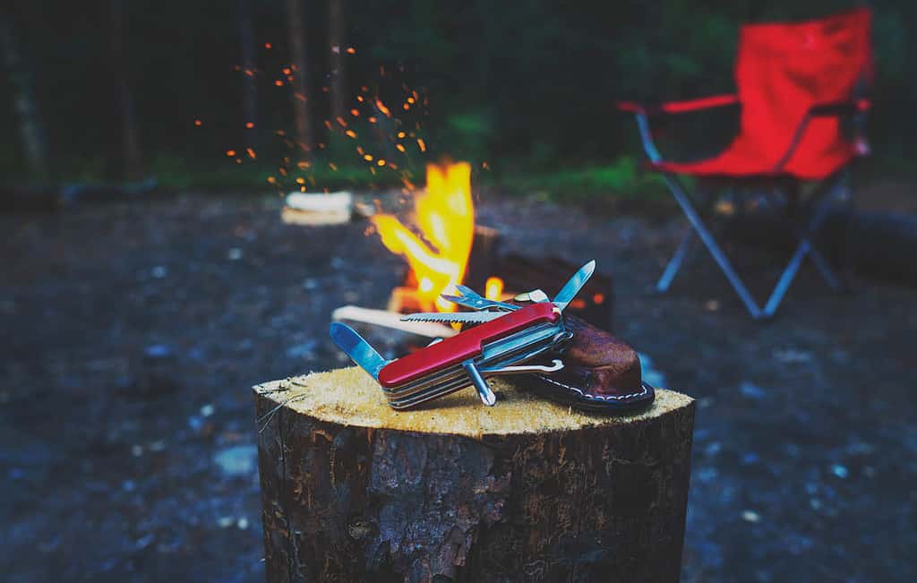 Camping site with fire and utility knife tool