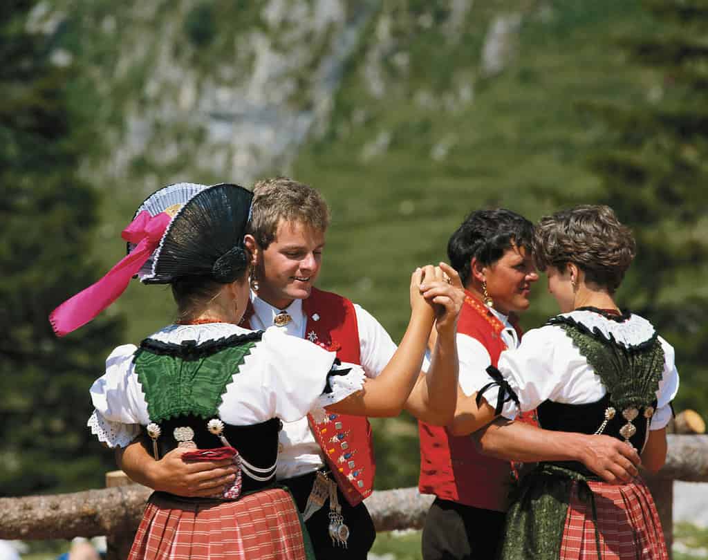 Dancing people in traditional switzerland clothes