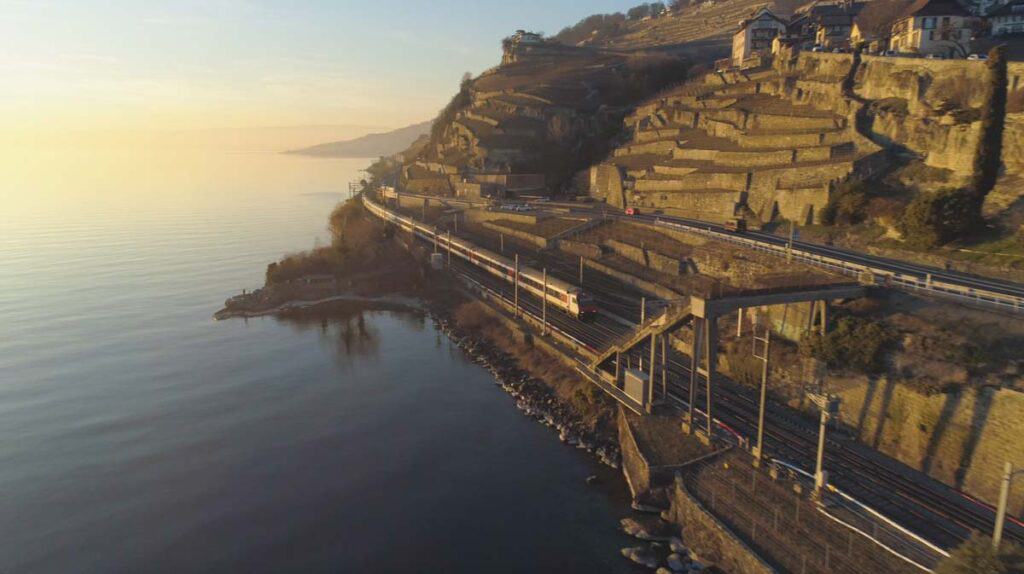 aerial view at lake brienz with a train and the lavaux vineyards
