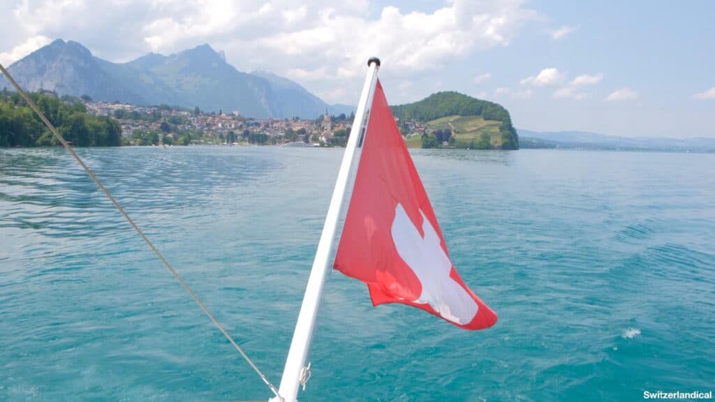 Look back towards the rear of the Bluemlisalp, where a Swiss flag is waving, in the distance the bay of Spiez.